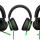 A photo of Microsoft's 20th Anniversary Xbox Wired Headset, with green accents and translucent black ear cups.